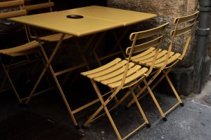 Yellow Foldable Chairs and Tables on the Concrete Pavement