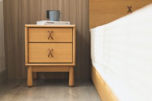 white ceramic mug on brown wooden nightstand