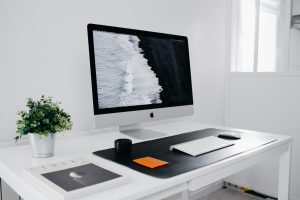 silver imac on white wooden table