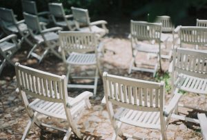 empty white wooden folding chairs