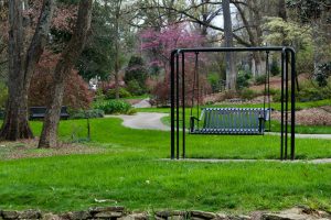 a park with a bench and a swing in it